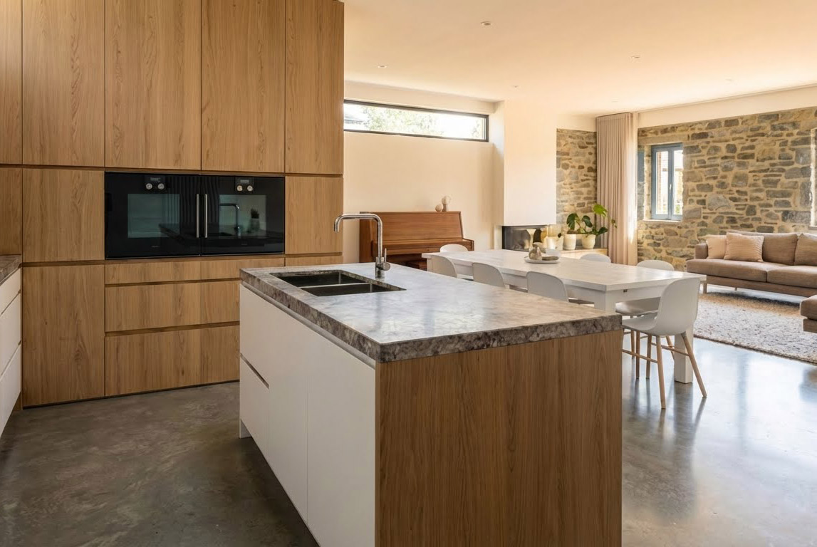 Open living room with kitchen and blue poufs